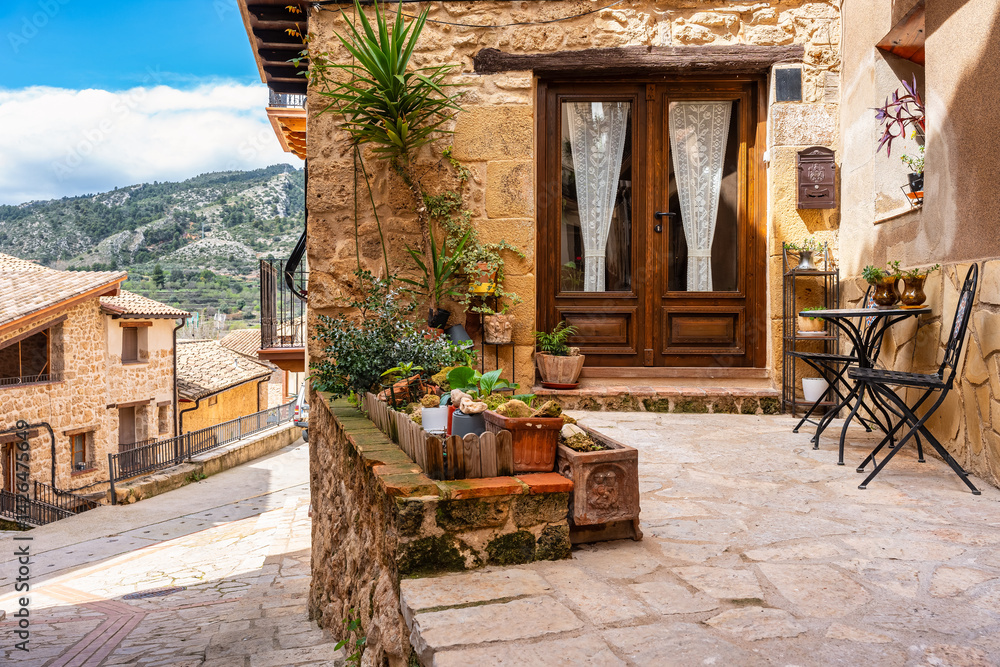 Picturesque corner with chairs and table to get some fresh air in the town of Beceite, Teruel.