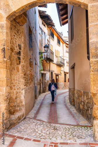 Obraz na płótnie Tourist woman strolling through the picturesque streets of the beautiful medieval town of Beceite, Teruel. w salonie