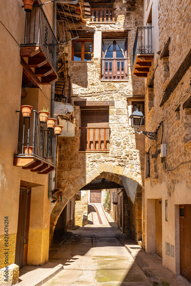 Beautiful corner of the town of Beceite with stone arches that form the houses on the narrow streets, Teruel.