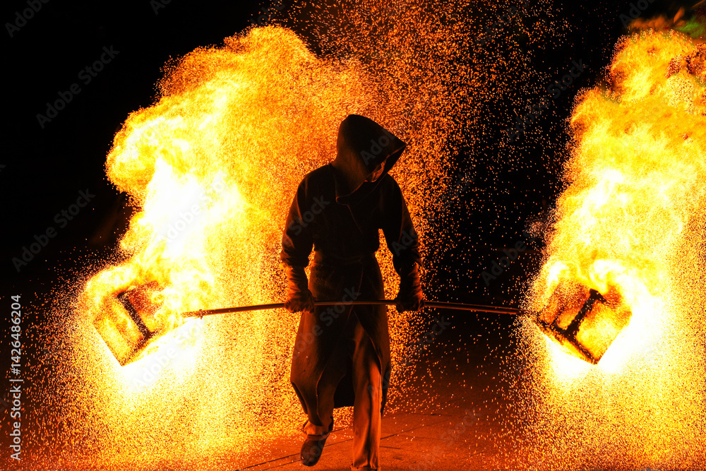 Unknown man holding a bar of fire with many spark Unknown man holding a bar of fire with many spark