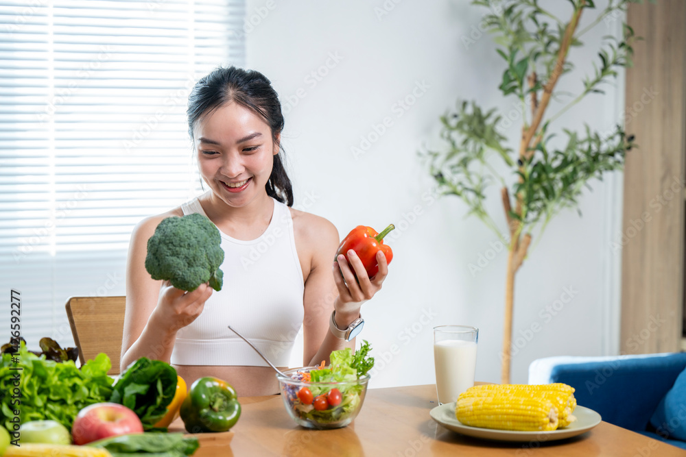A woman is smiling while holding a broccoli and a pepper A woman is smiling while holding a broccoli and a pepper