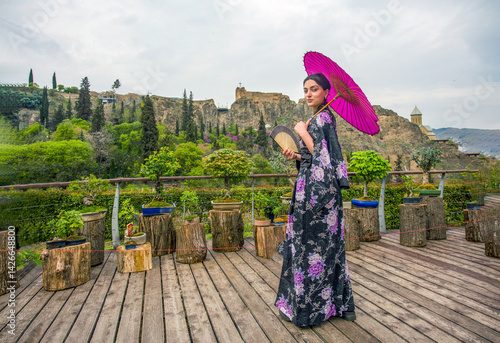 Obraz na płótnie Beautiful young woman in Japanese kimono and and smile as Mona Lisa (on holiday of cherry blossom in Georgian capital) Tbilisi
w salonie