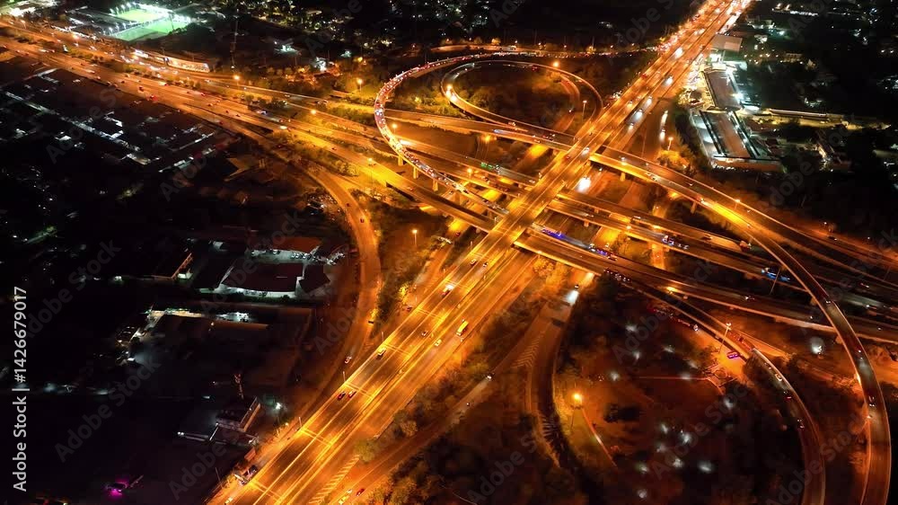 Stunning aerial view of illuminated highway light trails at night, showcasing dynamic movement and urban landscape. Perfect for concepts of speed, transportation, Expressway Stunning aerial view of illuminated highway light trails at night, showcasing dynamic movement and urban landscape. Perfect for concepts of speed, transportation, Expressway