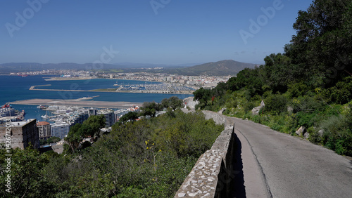 Winding road descending from the Rock of Gibraltar overlooking the city, harbor, and airport - GIBRALTAR, UK - MARCH 31, 2025
