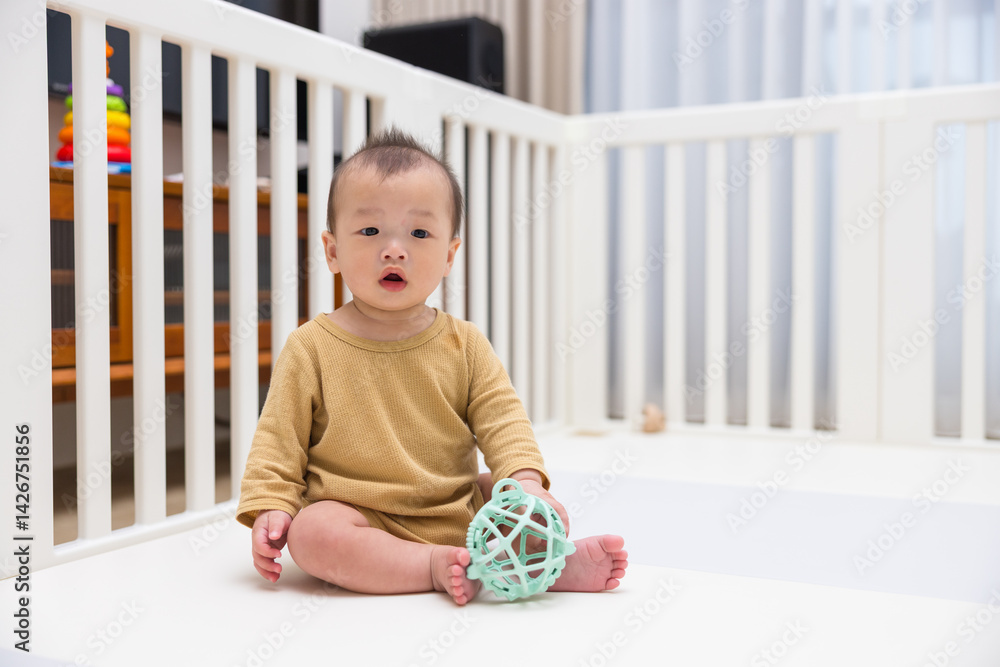 Baby Sitting in Playpen Indoors at Home