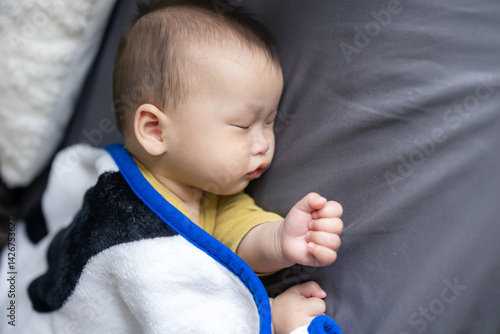 Baby Sleeping Soundly on Bed in Nursery