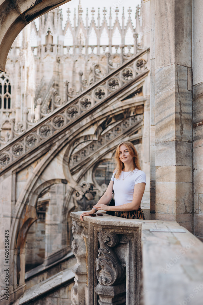 Female traveler standing on the rooftop of Duomo cathedral in Milan. Having great vacations in Milan