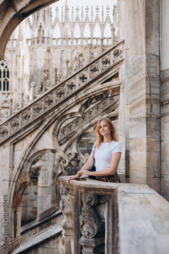 Obraz na płótnie Female traveler standing on the rooftop of Duomo cathedral in Milan. Having great vacations in Milan w salonie