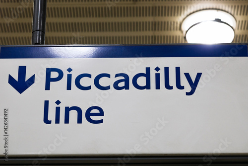 Photos Clear Piccadilly Line Sign with Downward Arrow in London Underground Station