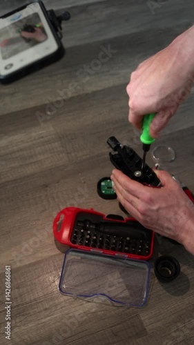 Wallpaper Mural Vertical screen real-time AI support helps fix electronic devices at home guiding step by step through video while tools and parts are arranged on the floor for hands-on repair Torontodigital.ca