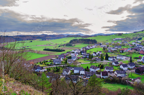 Village in the highlands of Germany against the backdrop of sky, fields and mountains