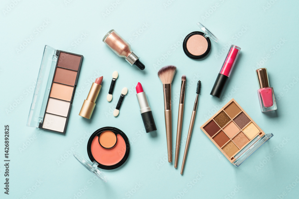 Beauty products for professional make up on blue background. Flat lay.