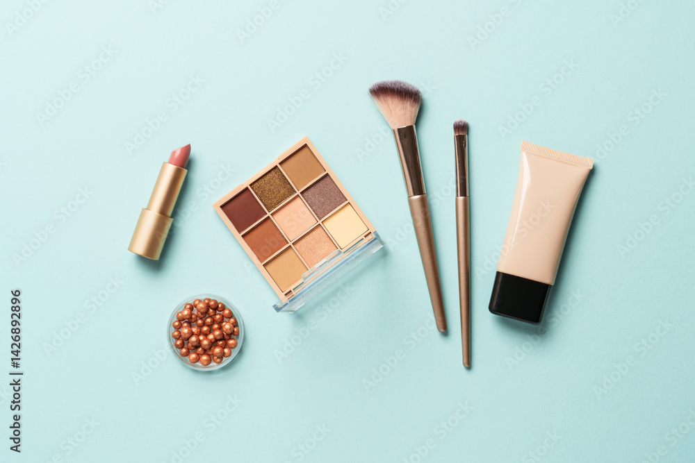 Beauty products for professional make up on blue background. Flat lay.