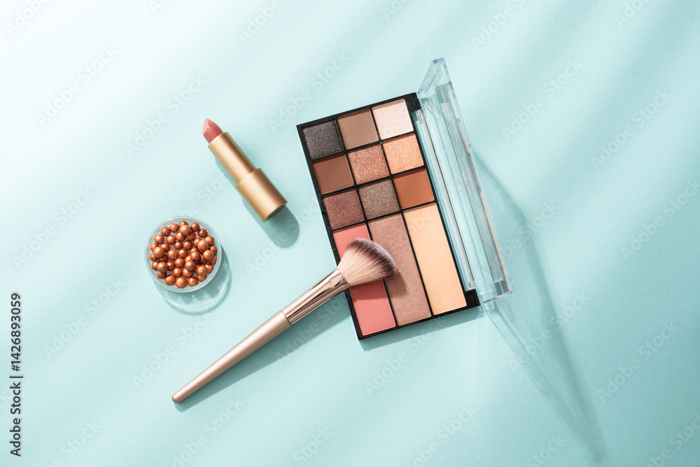 Beauty products for professional make up with shadows. Flat lay on blue background.