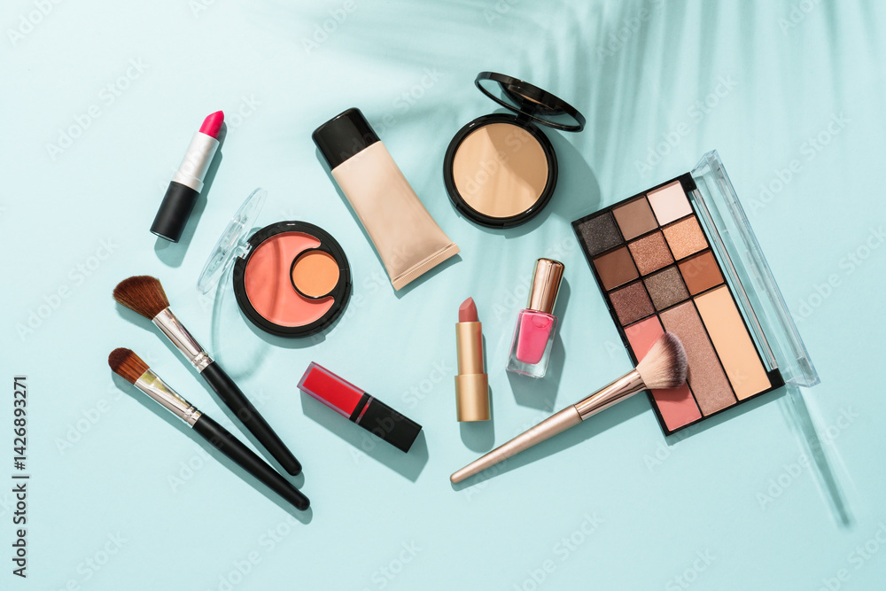 Beauty products for professional make up on blue background. Flat lay.