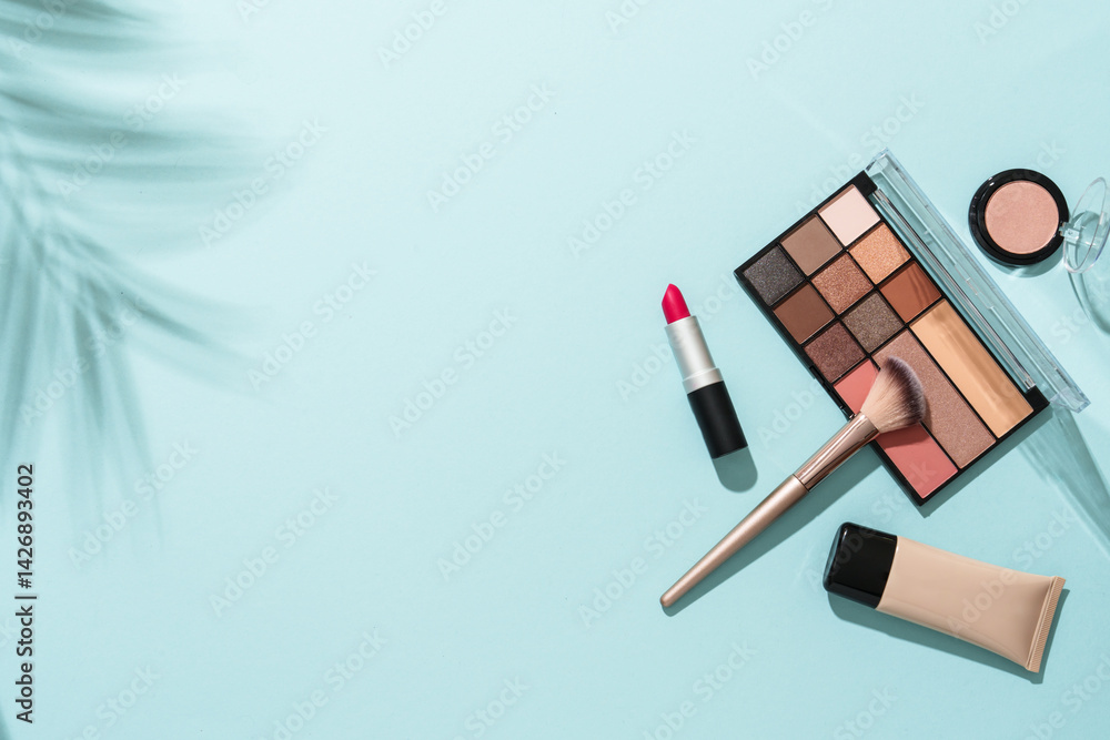 Beauty products for professional make up with shadows. Flat lay on blue background.