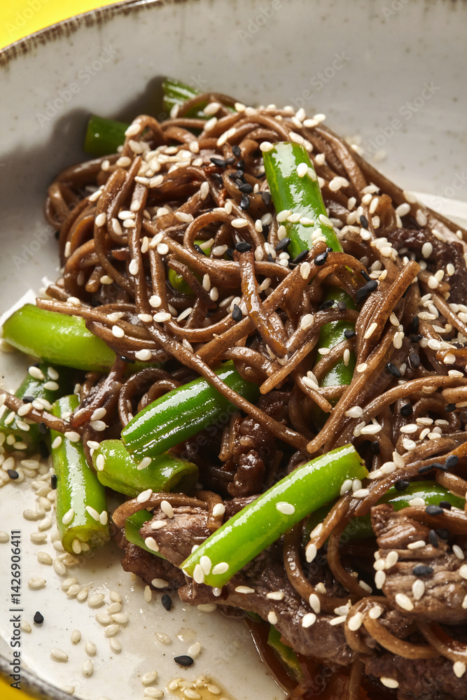 Soba noodles with beef and green beans sprinkled with sesame seeds