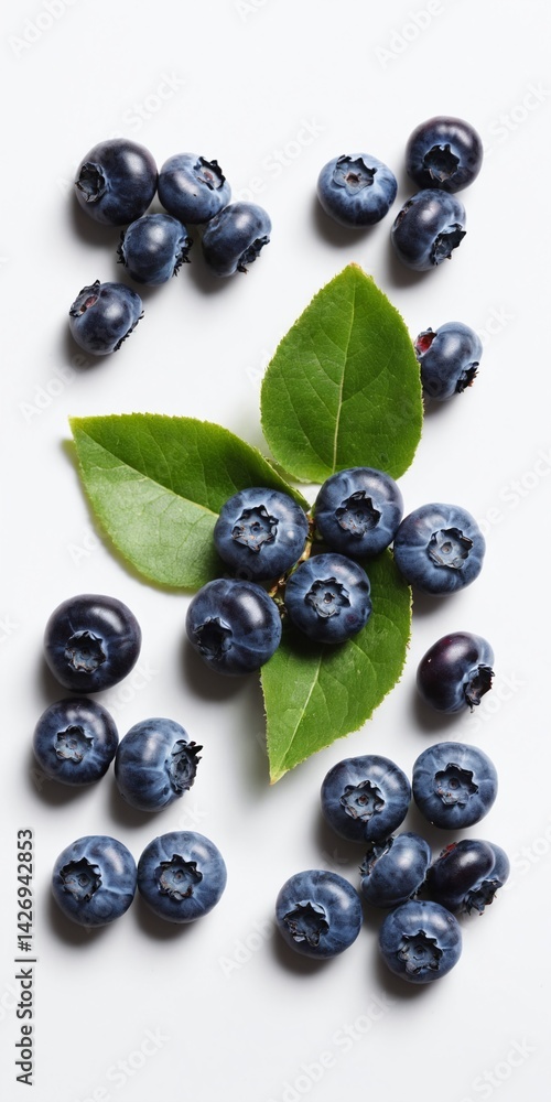 Fresh raw blueberry with green leaves on white. Top view flat lay