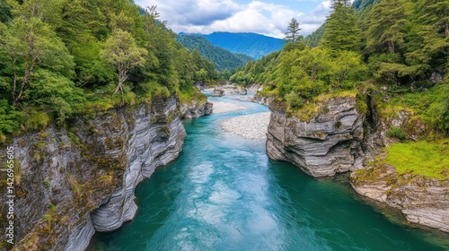 Turquoise river winding through lush mountains