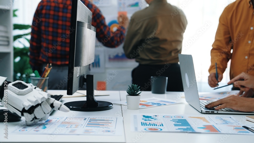 Fototapeta premium A dynamic office scene showcasing teamwork and collaboration among professionals engaging with charts and technology. The atmosphere promotes productivity and innovation.Noogenesis