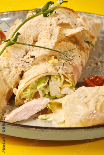 Obraz na płótnie Caesar wrap with chicken, parmesan and croutons on yellow background w salonie