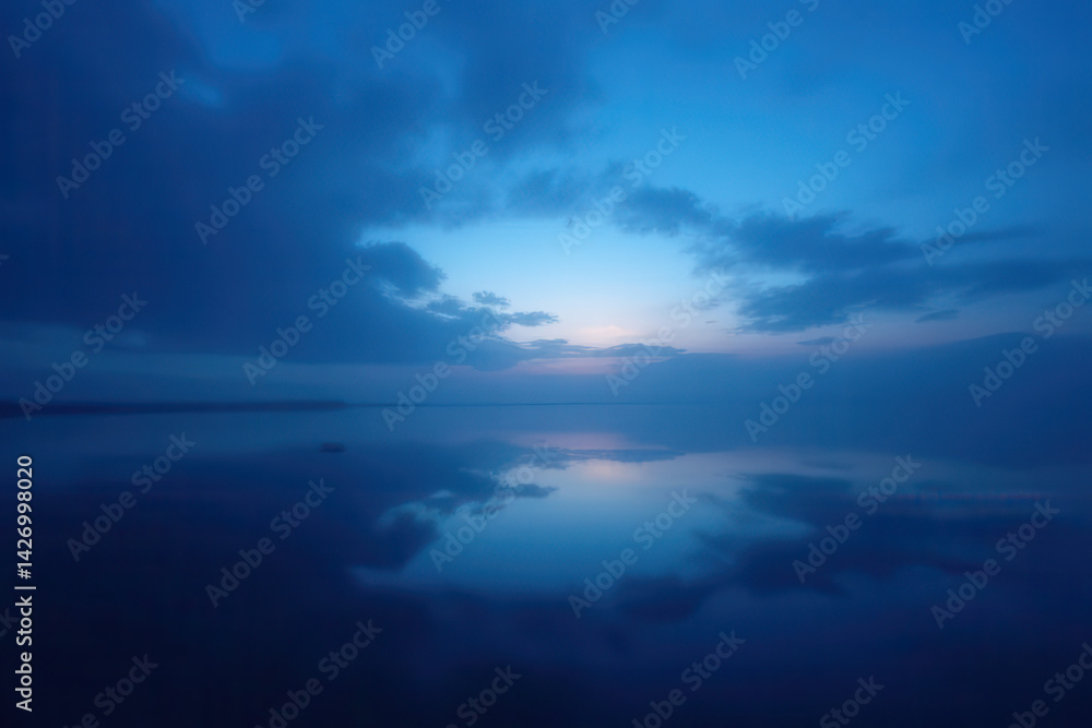 Fototapeta premium Tranquil Afterglow Scene: Soft Silhouettes in Blue and Black Hues, Fading Sky with Delicate Dim Light