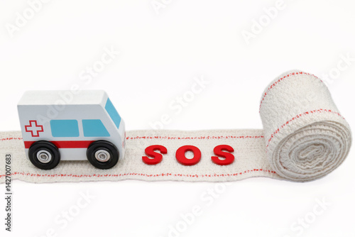 Obraz na płótnie Miniature ambulance running on a bandage with sos message symbolizing medical emergency and healthcare w salonie