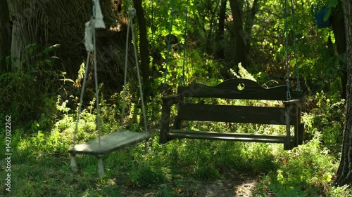 Wooden swing in the forest