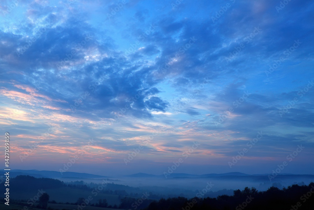A breathtaking dawn scene with pastel skies over rolling hills shrouded in mist, creating a serene and picturesque landscape in the early morning light. A breathtaking dawn scene with pastel skies over rolling hills shrouded in mist, creating a serene and picturesque landscape in the early morning light.
