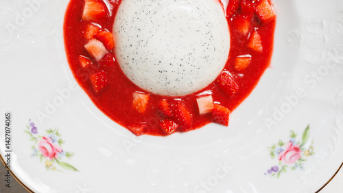 Panna cotta with strawberry jam in a white plate. Dessert, restaurant food presentation photo