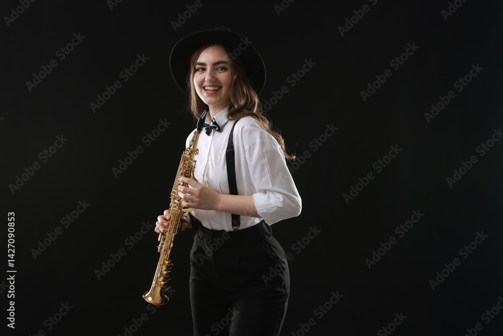 Naklejka premium Musician with soprano saxophone on dark background