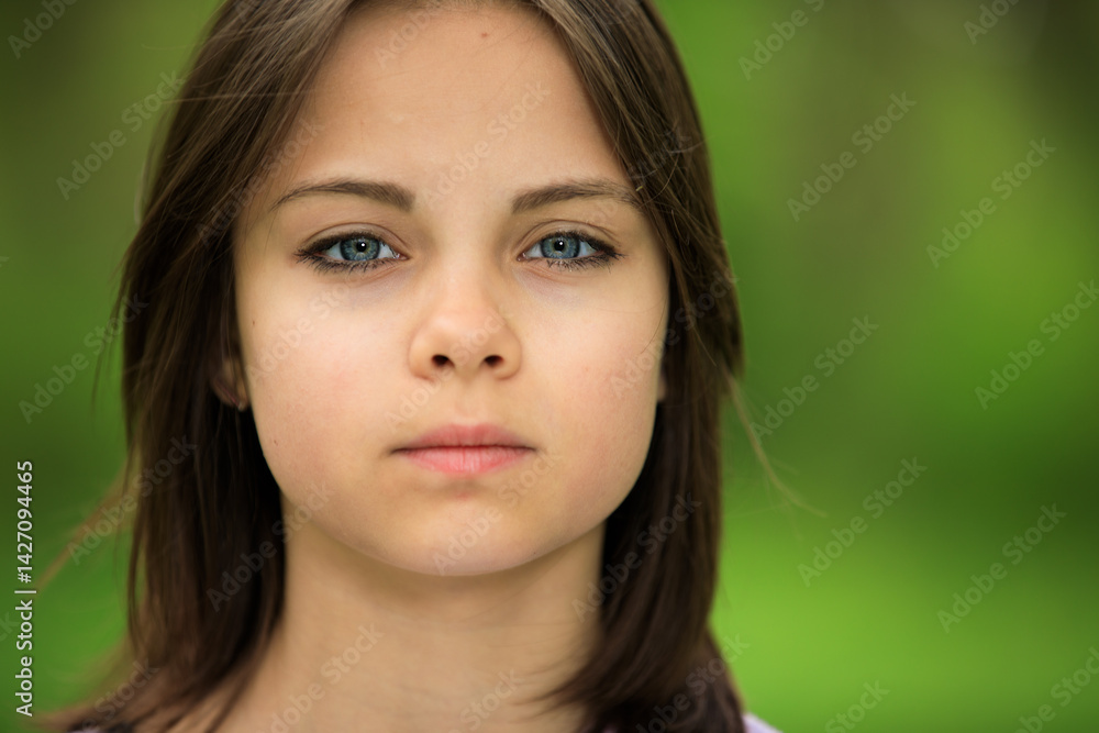 Portrait of preteen girl in park in spring.