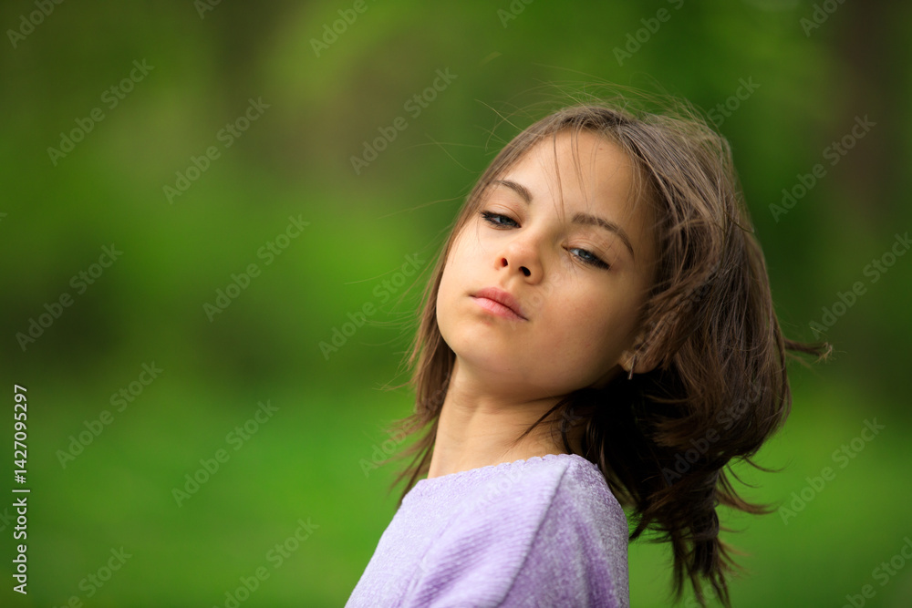 Portrait of preteen girl in park in spring.