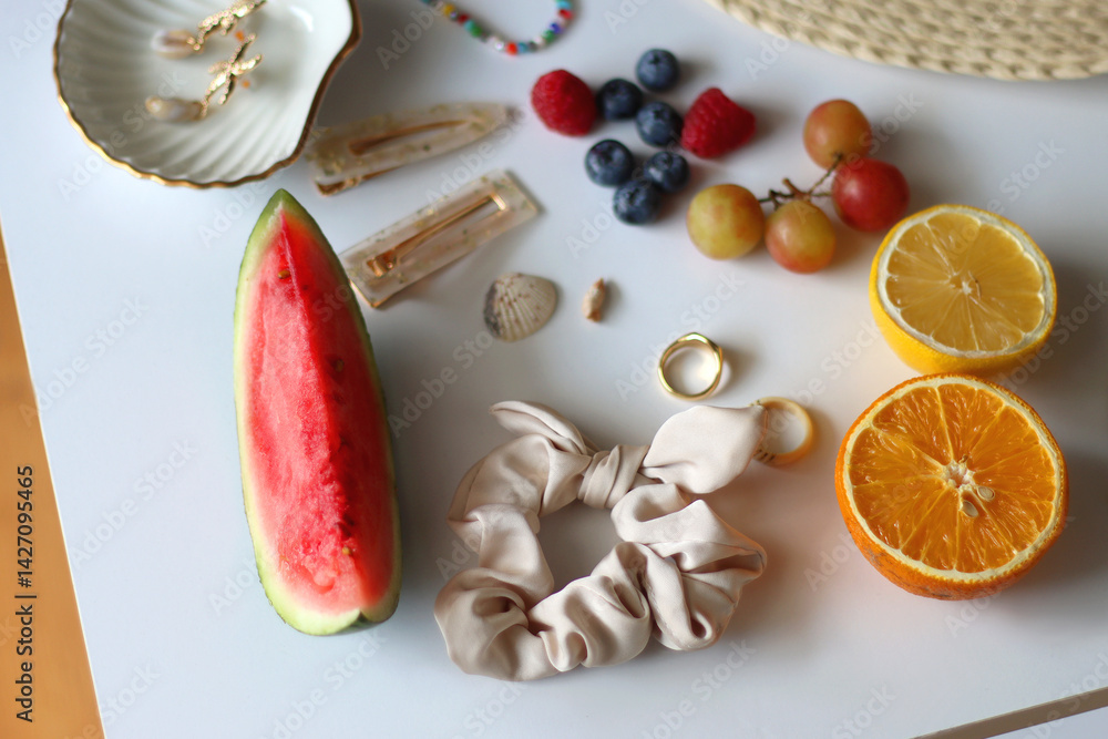 Straw hat, sunglasses, seasonal fruit, seashells and colorful accessories on white backgrounds. Cute summer essentials. Selective focus.