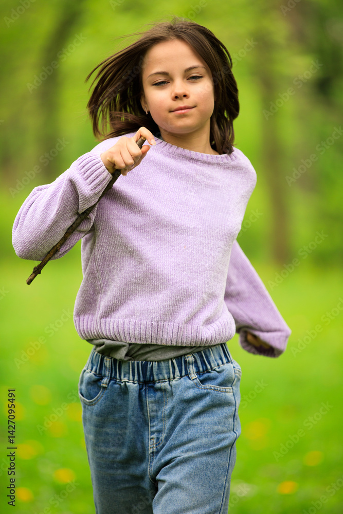 Portrait of preteen girl in park in spring.