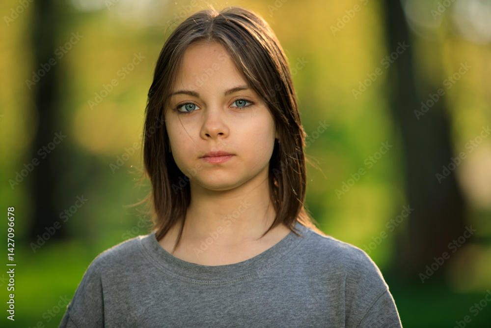 Portrait of preteen girl in park in spring.