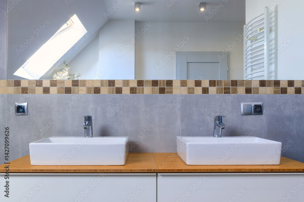 Modern bathroom interior with gray tiles and wooden decors