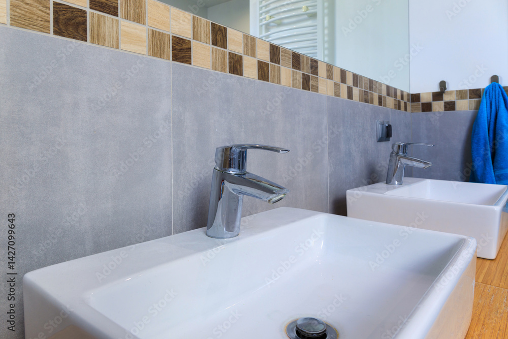 Modern bathroom interior with gray tiles and wooden decors