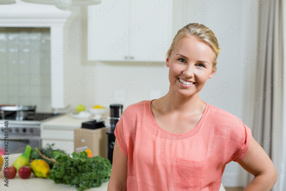 Woman preparing fresh juice in modern home kitchen, with blender base and fresh produce, copy space Woman preparing fresh juice in modern home kitchen, with blender base and fresh produce, copy space