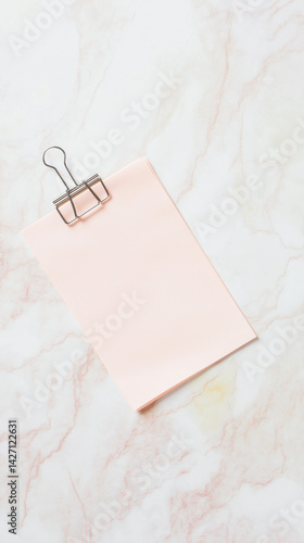 A sticky note with a paperclip
