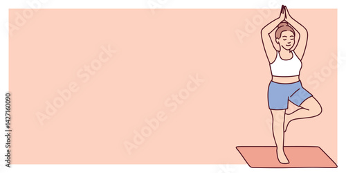 Slim woman performs tree pose during yoga practice on mat. Standing on one leg with arms raised in quiet and focused balance. Additional space for text