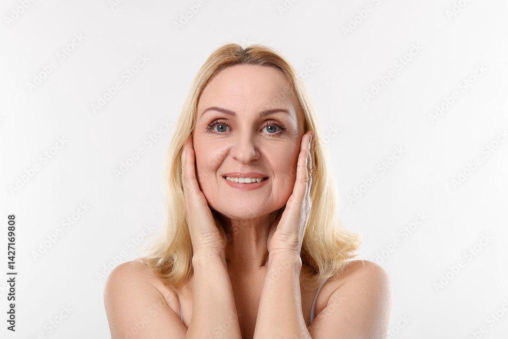 Portrait of smiling middle aged woman on white background Portrait of smiling middle aged woman on white background