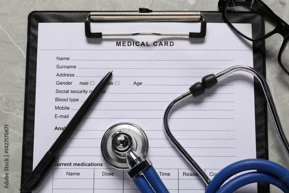 Flat lay composition with medical card form on grey background