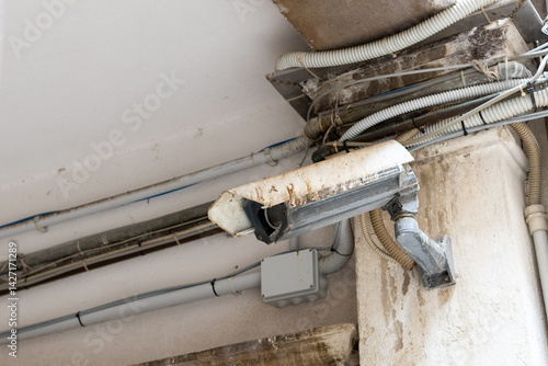 Rusty Surveillance Camera with Exposed Wiring