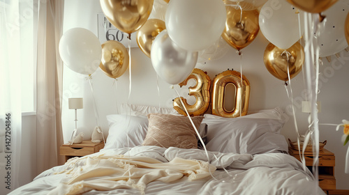 Elegant bedroom decorated with gold and white balloons and large golden number 30 balloons to celebrate a 30th birthday