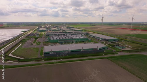 Tech data hub powered by wind in modern Dutch landscape. Aerial drone video