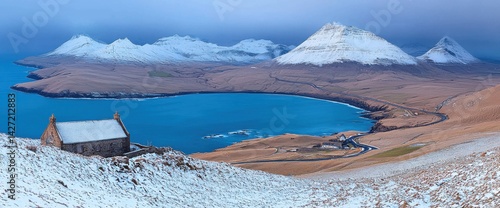 Majestic winter landscape in Faroe Islands with snow-capped mountains and lake