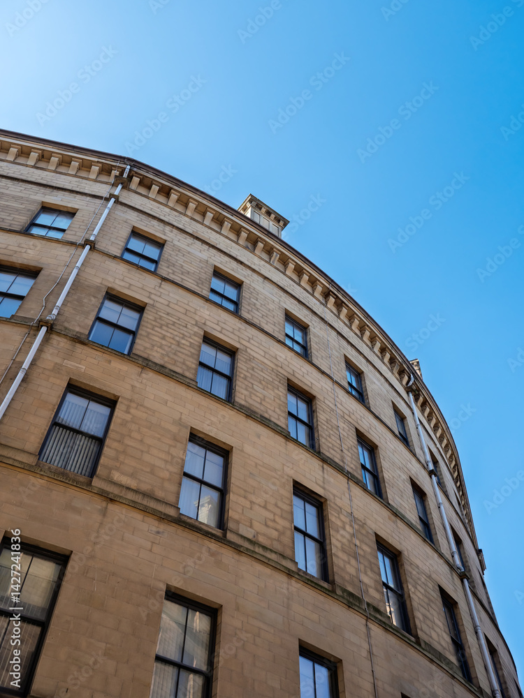 Fototapeta premium corner of a tall curved 19th century neoclassical building in the Bradford Little Germany District