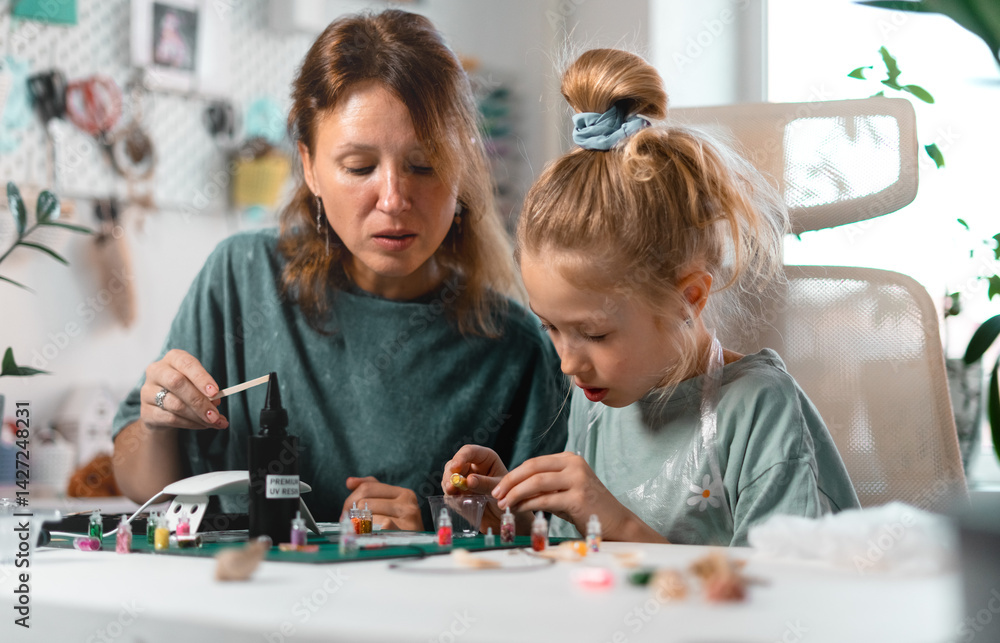 Engaging crafting experience where child immerses in handmade jewelry-making, carefully decorating resin pieces. Parent-child collaboration strengthens emotional connection. Engaging crafting experience where child immerses in handmade jewelry-making, carefully decorating resin pieces. Parent-child collaboration strengthens emotional connection.