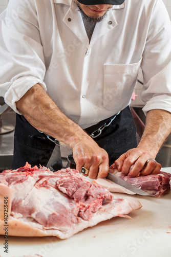butcher breaking down meat